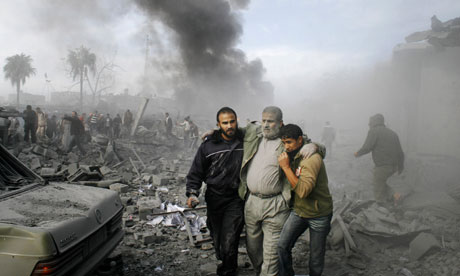 An injured Palestinian is helped from the rubble following an Israeli missile strike in the Gaza Strip on Saturday 27 December, 2008. Photograph: Hatem Omar/AP