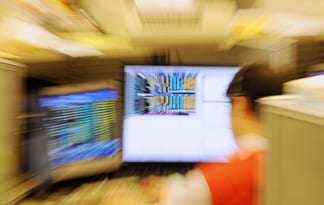 A trader looks at his computer screen on