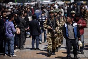 Armed paramilitary policemen patrol near the Kunming Railway Station in Kunming, in western China's Yunnan province Sunday, March 2, 2014. More than 10 assailants slashed scores of people with knives...   (Associated Press)