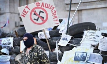 The barricades outside the Donetsk regional administration building are plastered with anti-fascist posters. Photograph: Scott Olson/Getty Images