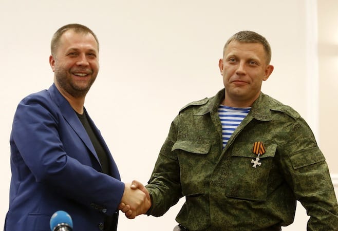 Alexander Borodai the Prime Minister of the self proclaimed "Donetsk People's Republic" shakes hands with Alexander Zakharchenko, who heads a heavily armed rebel unit called Oplot during their news conference in Donetsk