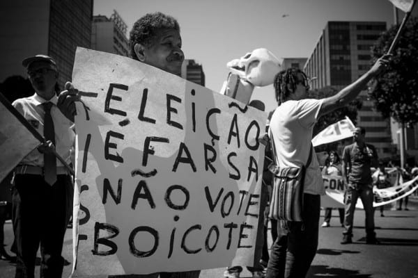 "Elections are a farce" reads the placard. The feeling that society is sick is pervasive. But it's not so much Dilma's government as the system itself.