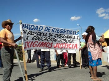 "We demand Justice" proclaims the banner held by local villagers. (click to enlarge)