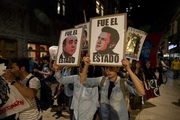 n Mexico City, demonstrators march with signs saying "It was the state" and showing images of Mexican President Enrique Peña Nieto, right, and Atty. Gen. Jesus Murillo Karam in a protest over the disappearance of 43 college students. November 14, 2014, 11:19 p.m. Eduardo Verdugo / Associated Press