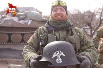 Donbass fighter showing Nazi-emblemed helmet belonging to one of the neonazi battalions sent by Kiev to punish the rebels. 