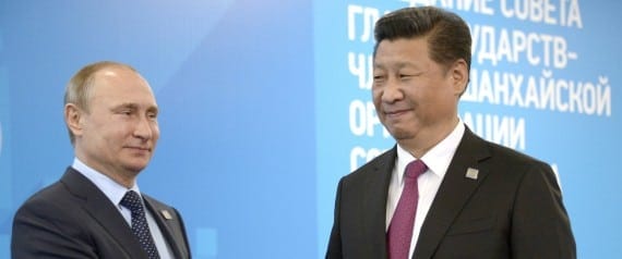 Russian President Vladimir Putin (L) greets Chinese President Xi Jinping during a welcome ceremony in Ufa on July 10, 2015 at the start of the Shanghai Cooperation Organization (SCO) summit. AFP PHOTO / ALEXANDER NEMENOV        (Photo credit should read ALEXANDER NEMENOV/AFP/Getty Images)