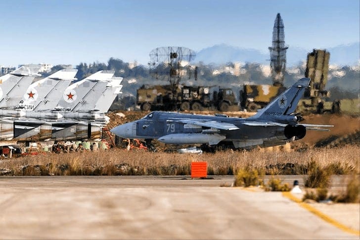 A Su-24 tactical bomber taxies in the Latakia AFB. An S-400 anti-aircraft battery can be seen in the background. 