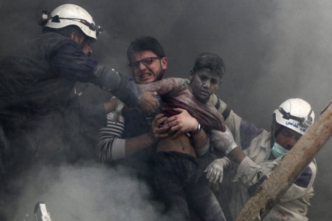 ATTENTION EDITORS - VISUAL COVERAGE OF SCENES OF INJURY OR DEATH Men rescue a boy from under the rubble after what activists said was explosive barrels dropped by forces loyal to Syria's President Bashar Al-Assad in Al-Shaar neighbourhood of Aleppo April 6, 2014. REUTERS/Hosam Katan (SYRIA - Tags: POLITICS CIVIL UNREST CONFLICT TPX IMAGES OF THE DAY) - RTR3K52P