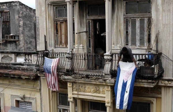 Cuban displaying two old flags of the host and guest nations.